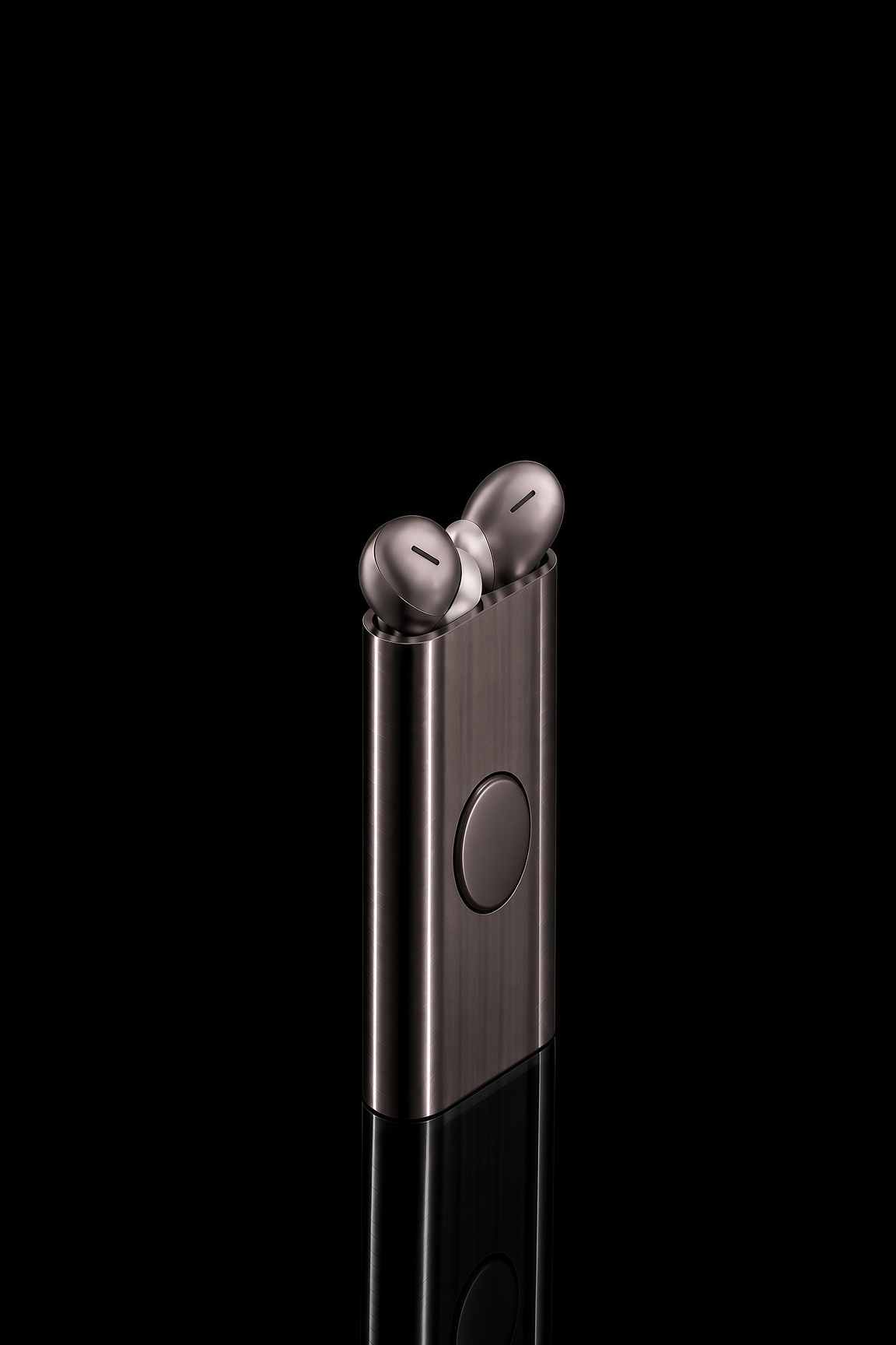The Reel console: a slim brushed aluminium body with earpieces in shallow top recesses and a circular magnetic pebble on the front.